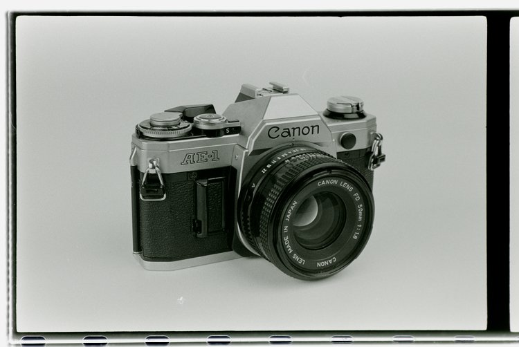 The Canon AE-1 is a 35mm film SLR camera that revolutionized the photography world in the 1970s, celebrated for its intuitive controls, durable design, and unparalleled compatibility with a myriad of exceptional Canon FD lenses.