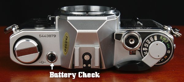 Battery Check on top plate near film rewind