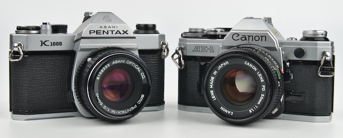 The Canon AE-1 and Pentax K1000 are the two most commonly recommended cameras for beginners. We take a look at the pros and cons of each.