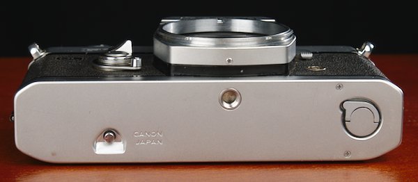 Bottom plate of the Canon 35mm camera with the film rewind lock and film door switch