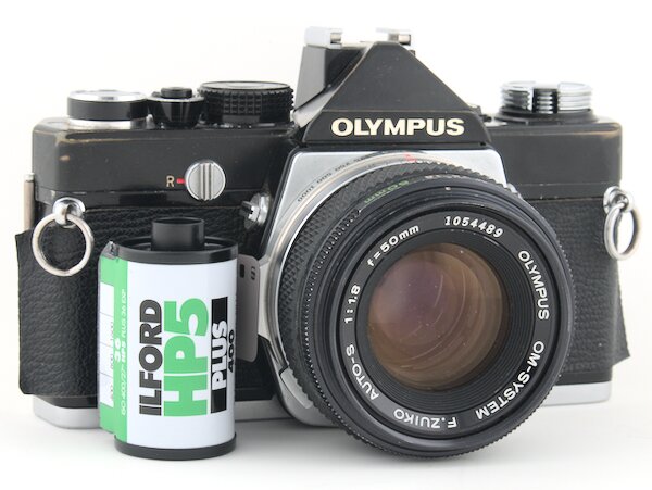 Step by step instructions with pictures on how to load 35mm film into the Olympus OM-1 camera. Start taking photos with your Olympus OM-1 camera today.
