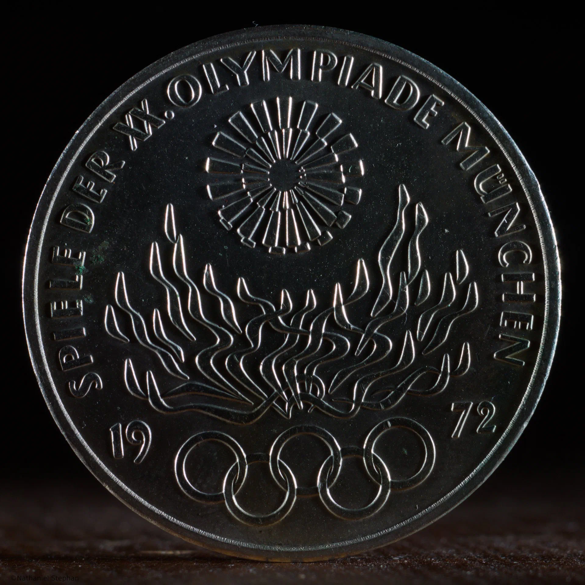 1972 Munich Olympics 10 Mark Coin – Lighting Study 2 1972 Munich Olympics 10 Mark silver coin photographed under a second lighting condition to reveal relief and texture