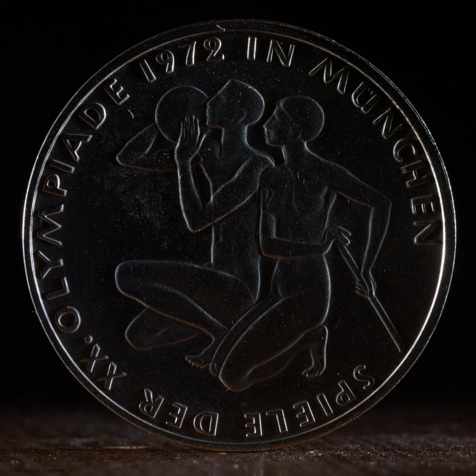 1972 Munich Olympics 10 Mark Coin – Lighting Study 3 1972 Munich Olympics 10 Mark silver coin photographed under a third lighting condition to highlight surface detail