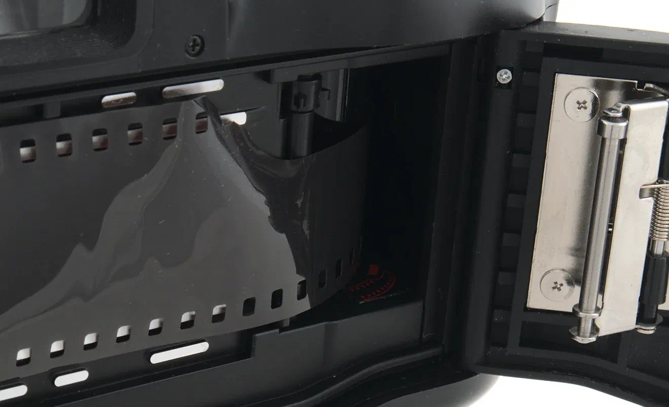 Pull film leader over to Nikon N70 take-up spool
