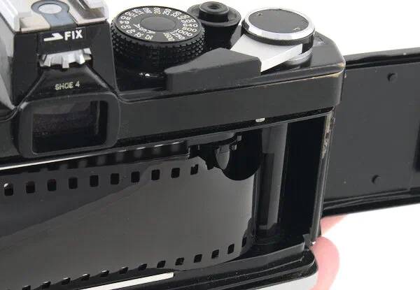 Insert the film leader into the Olympus OM-1 take-up spool