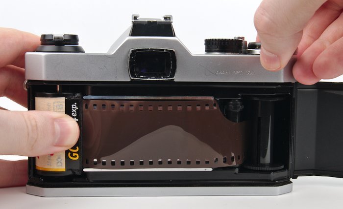 Hold Film Canister and Advance the Film