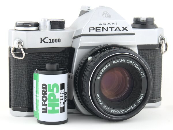 Step by step instruction on how to load film into a Pentax K1000 camera. Every step has a picture to help you see exactly what to do.